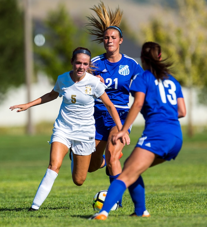 (Chris Detrick | The Salt Lake Tribune) Davis' Zoe Jacobs (5) Fremont's Ambree Gibson (21) and Fremont's Berkley Heileson (13) go for the ball during the game at Angel Street Soccer Complex in Kaysville Thursday, August 24, 2017. Fremont defeated Davis 5-4 in double overtime.