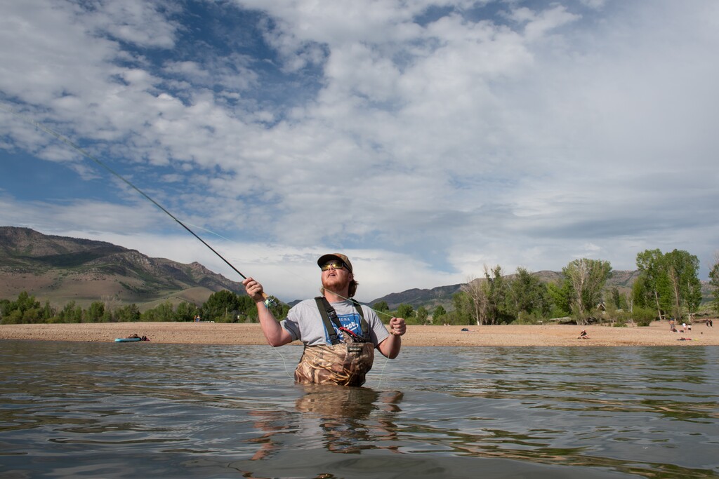 (Briana Scroggins | Special to The Tribune) Hunter Elster of Salt Lake City fly fishes in Pineview Reservoir on Wednesday, June 9, 2021. “Last year the water was up to that tree line,” Elster said as he gestured to the trees behind him. Pineview Reservoir is considerably lower than it was this time last year.