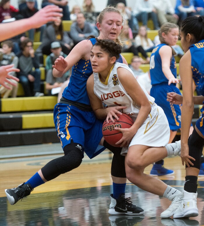 (Rick Egan  |  The Salt Lake Tribune)   Emily Garcia (1), Judge Memorial tries to get past San Juan guard Bodell Nielson (25), in 3A Women's basketball State playoff action Judge Memorial Vs. San Juan, in Heber City, Friday, Feb. 16, 2018.
