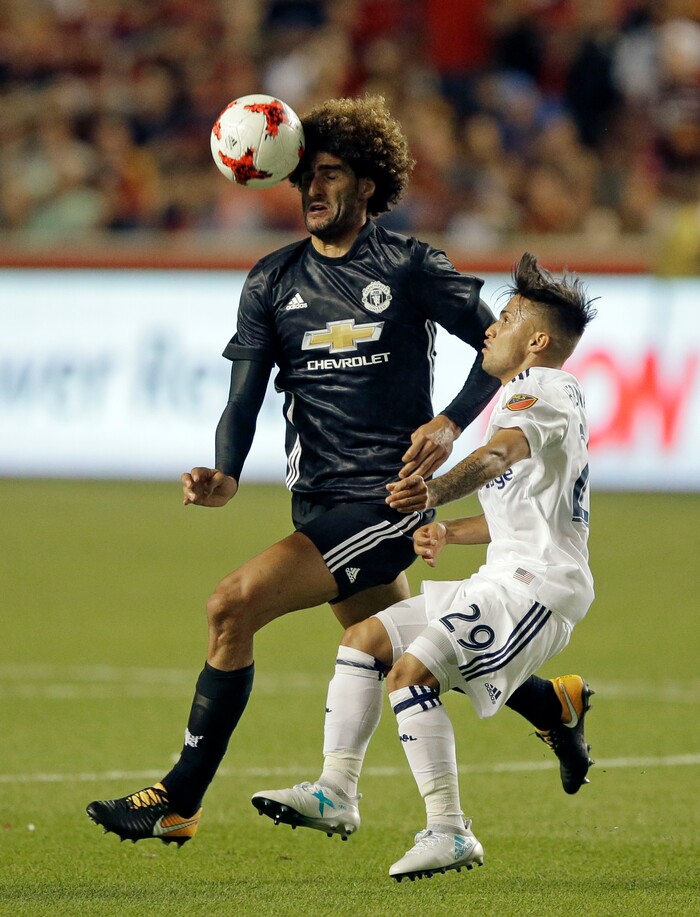 Manchester United midfielder Marouane Fellaini, rear, and Real Salt Lake midfielder Jose Hernandez (29) vie for the ball during the second half of a friendly soccer match Monday, July 17, 2017, in Sandy, Utah. (AP Photo/Rick Bowmer)