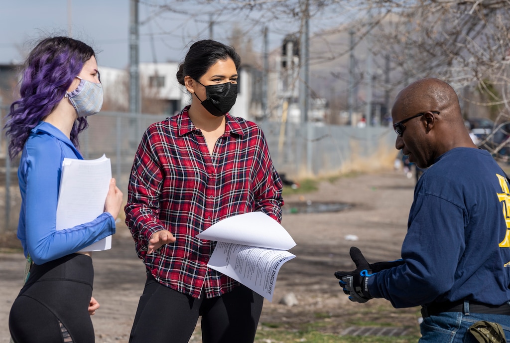 (Rick Egan | The Salt Lake Tribune) Marina and Jeanette Padilla from the Food Justice Coalition, talk to Kevin Thrower while passing out information on how people experiencing homelessness can claim their covid stimulus checks, on Thursday, March 18, 2021.
