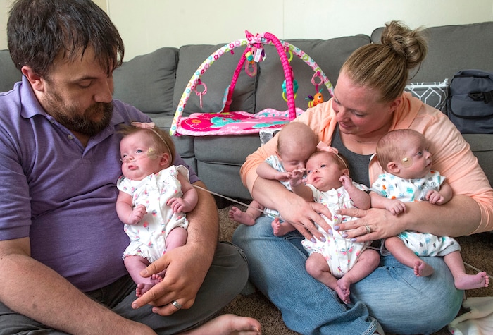 (Rick Egan  |  The Salt Lake Tribune)       Allen Glines holds Reese, as Kayla holds Oaklee, Lincoln, Jamesen, at their home in Ogden, Saturday, June 15, 2019.