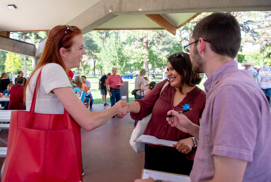 (Rachel Molenda  |  The Salt Lake Tribune)  Jennifer Dailey-Provost, left, a Democratic candidate for House District 24, shakes hands with Cinthia S. Cervantes, left, and Marcus Stevenson, right, of Utah Democrats, at a candidate meet-and-greet held by Crossroads Urban Center at Liberty Park in Salt Lake City on Wednesday, July 11, 2018.