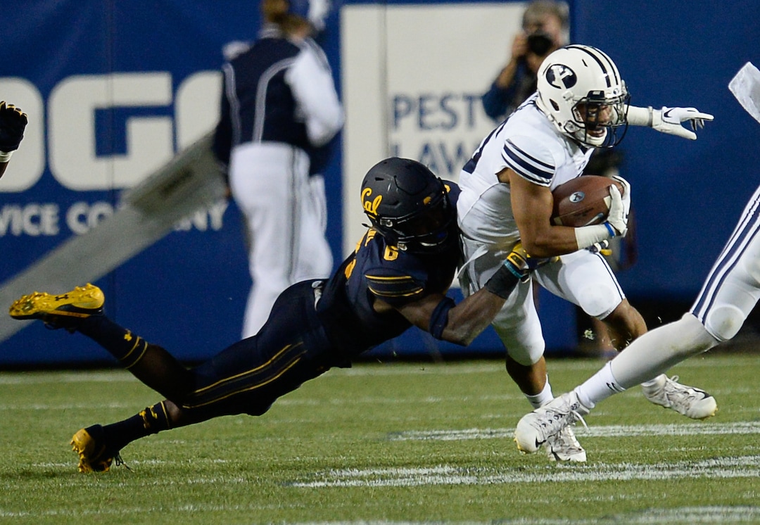 (Francisco Kjolseth  |  The Salt Lake Tribune)  California Golden Bears safety Jaylinn Hawkins (6) takes down Brigham Young Cougars wide receiver Aleva Hifo (15) during the first half of the NCAA college football game, Saturday, Sept. 8, 2018, at LaVell Edwards stadium in Provo, Utah.