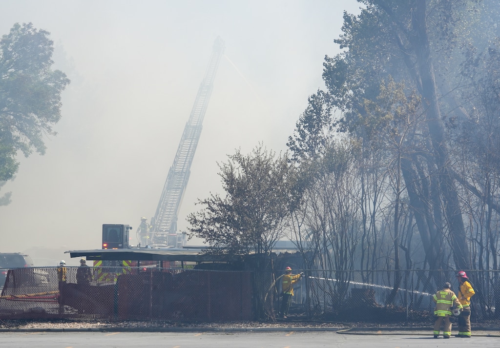 (Chris Samuels | The Salt Lake Tribune) Crews worked to battle the fire on 1300 East near Murray-Holladay Road in Millcreek, Friday, July 25, 2025. An investigation has documented what two Salt Lake City workers did after the fire was sparked by mowing, on a hot, windy day.