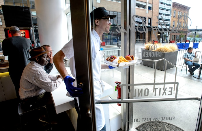 (Steve Griffin  |  The Salt Lake Tribune)  Chicken sandwiches are delivered to the patio at Pretty Bird, a new Nashville-style hot chicken restaurant on Regent Street, in Salt Lake City Monday April 23, 2018.