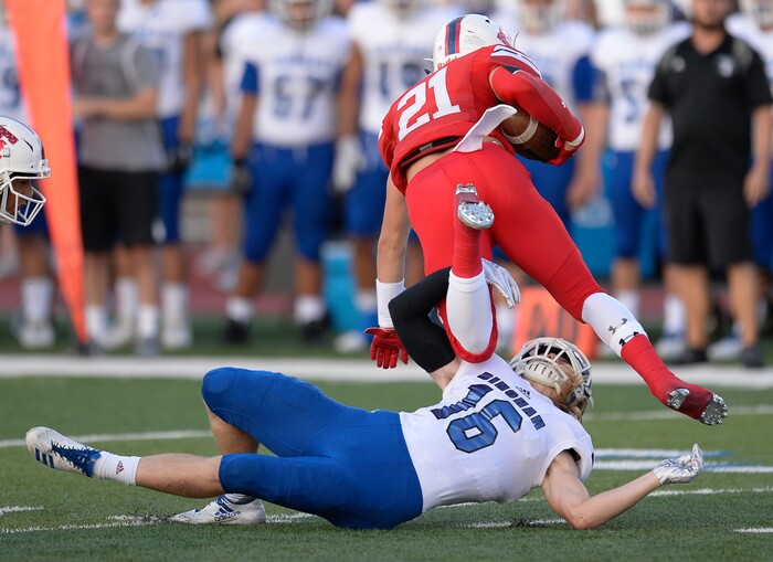 (Francisco Kjolseth  |  The Salt Lake Tribune)  Charlie Vincent of East High is taken down by Aiden Larsen of Bingham at East on Friday, Aug. 24, 2018.