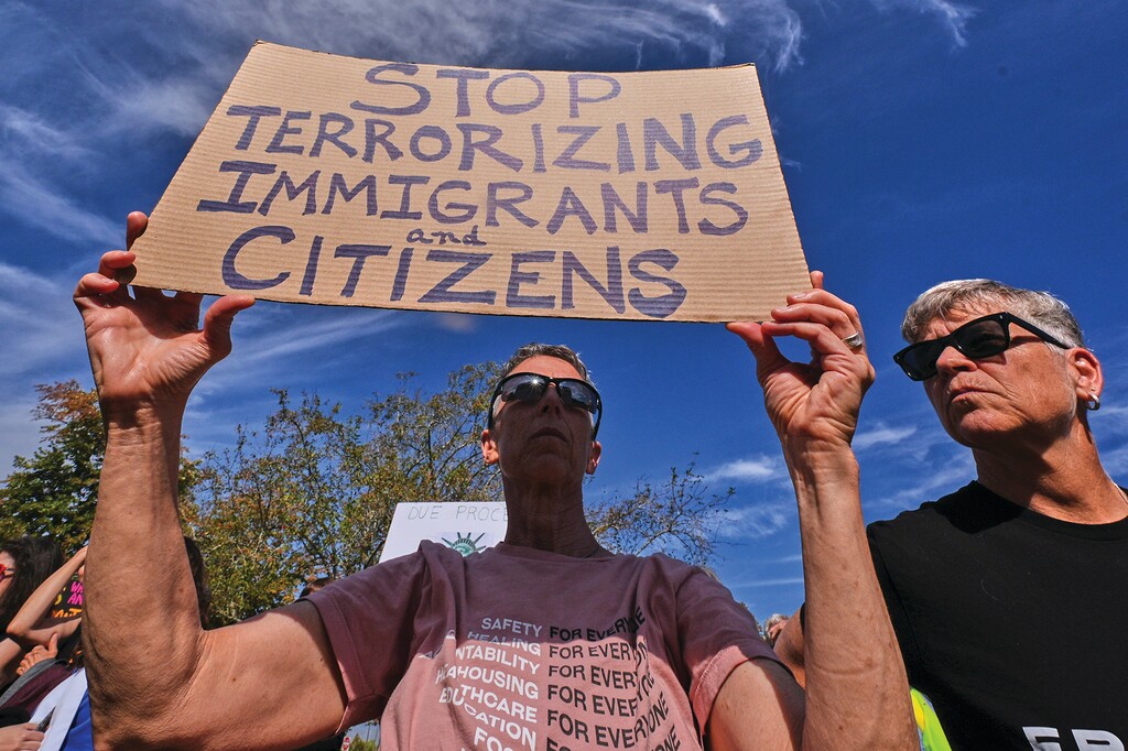 Protesters gather outside the U.S. Immigration and Customs Enforcement regional field office, Tuesday, Sept. 16, 2025, in Burlington, Mass. (AP Photo/Charles Krupa)
