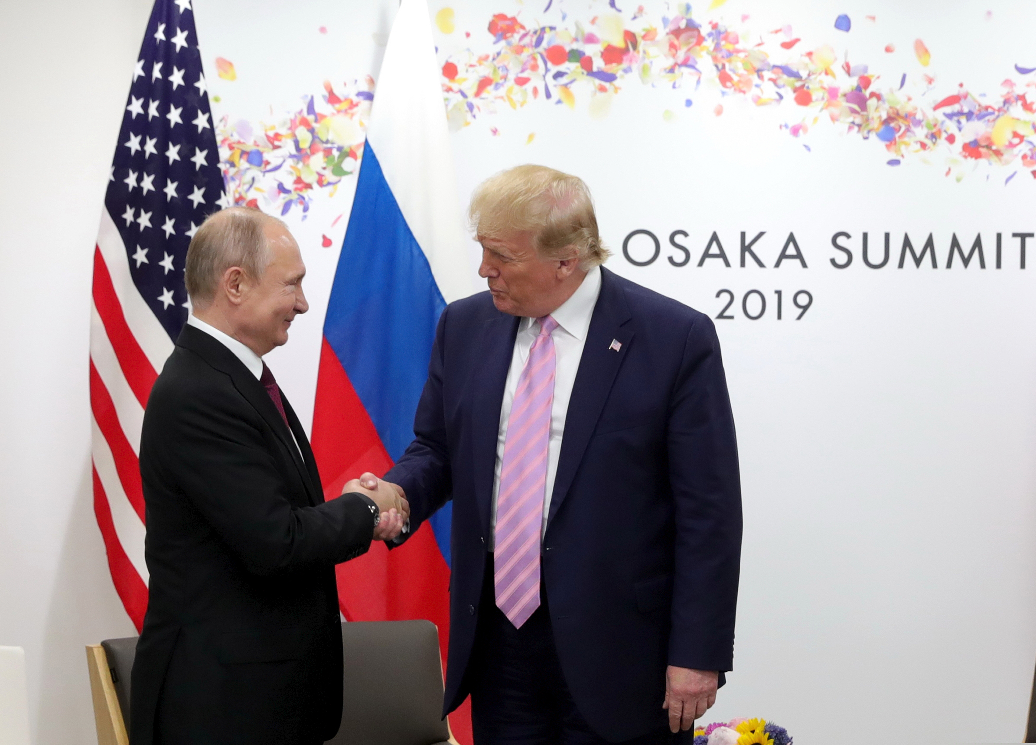 U.S. President Donald Trump, right, and Russian President Vladimir Putin greet each other during a bilateral meeting on the sidelines of the G-20 summit in Osaka, Japan, Friday, June 28, 2019. (Mikhail Klimentyev, Sputnik, Kremlin Pool Photo via AP)