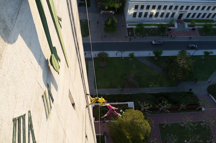 (Photo courtesy of Basil Tsimoyianis) Oakland, Calif.-based “vertical dance” company BANDALOOP performs during Cal Day in Berkeley, Calif. BANDALOOP will be appearing at the Utah Arts Festival June 21-24, and will perform twice daily (5:30 and 7 p.m.) on the six-story library glass wall above the reflecting pool.