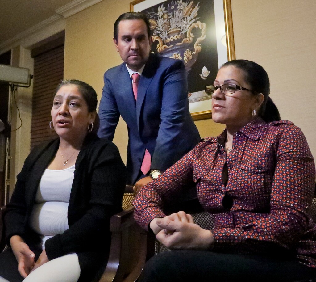 (Bebeto Matthews | AP file photo) Attorney Anibal Romero, center, joins his clients Victorina Morales, left, and Sandra Diaz, right, during an interview, Friday Dec. 7, 2018, in New York. Morales and Diaz, who recalled their experience working at President Donald Trump's golf resort in Bedminster, N.J., say they used false legal documents to get hired and supervisors knew it.