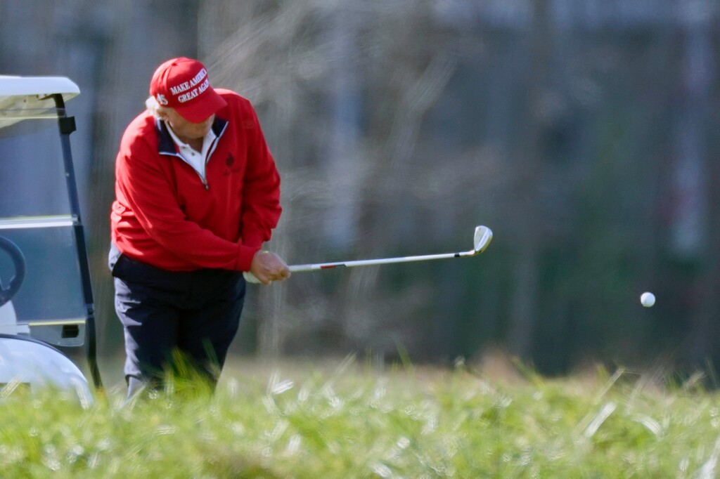 (Alex Brandon | AP) In this Nov. 28, 2020, photo former President Donald Trump plays golf at Trump National Golf Club in Sterling, Va.