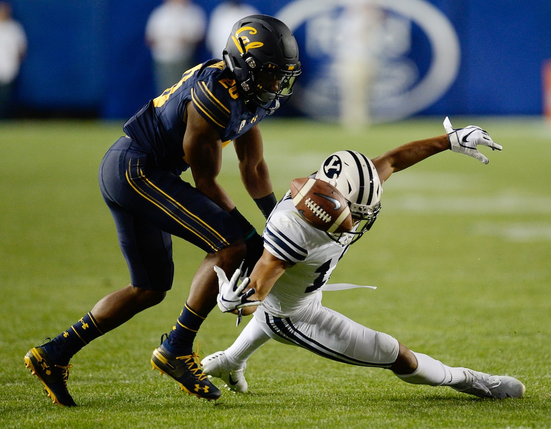 (Francisco Kjolseth  |  The Salt Lake Tribune)  California Golden Bears cornerback Josh Drayden (20) pressures Brigham Young Cougars wide receiver Micah Simon (13) during the second half of the NCAA college football game, Saturday, Sept. 8, 2018, at LaVell Edwards stadium in Provo, Utah.