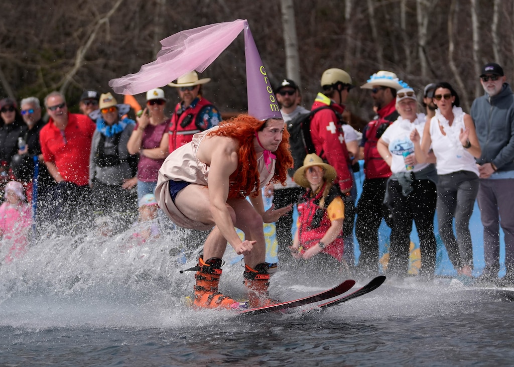 (Francisco Kjolseth  | The Salt Lake Tribune) Groom-to-be Andrew Voigt of Philadelphia skims across the pond for the 4th annual Eagle Super Pond Championship at Park City on Saturday, April 12, 2025. The 2024-25 season saw the second-most skier visits nationwide, according to the National Ski Areas Association.