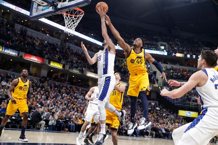 Utah Jazz guard Donovan Mitchell (45) arrives from behind to block the shot of Indiana Pacers center Goga Bitadze (88) during the first half of an NBA basketball game in Indianapolis, Wednesday, Nov. 27, 2019. (AP Photo/Michael Conroy)