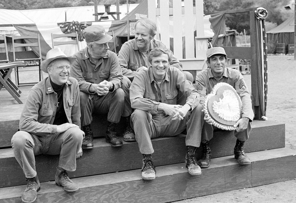 (Wally Fong | Associated Press file photo) In this Sept. 15, 1982, file photo, cast members of the television series "M*A*S*H" from left, William Christopher, Harry Morgan, Mike Farrell, Alan Alda, and Jamie Farr, take a break on the set during taping in Los Angeles.