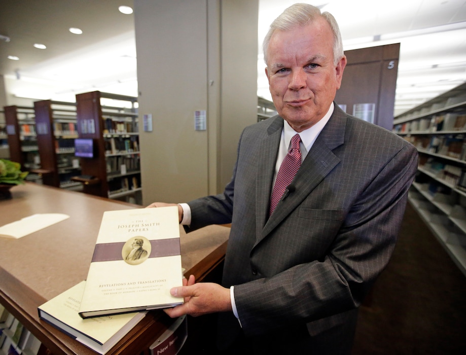 (Rick Bowmer | AP) Steven E. Snow displays a volume of the Joseph Smith Papers in 2015. The project was one of the major accomplishments during his time as historian of The Church of Jesus Christ of Latter-day Saints.