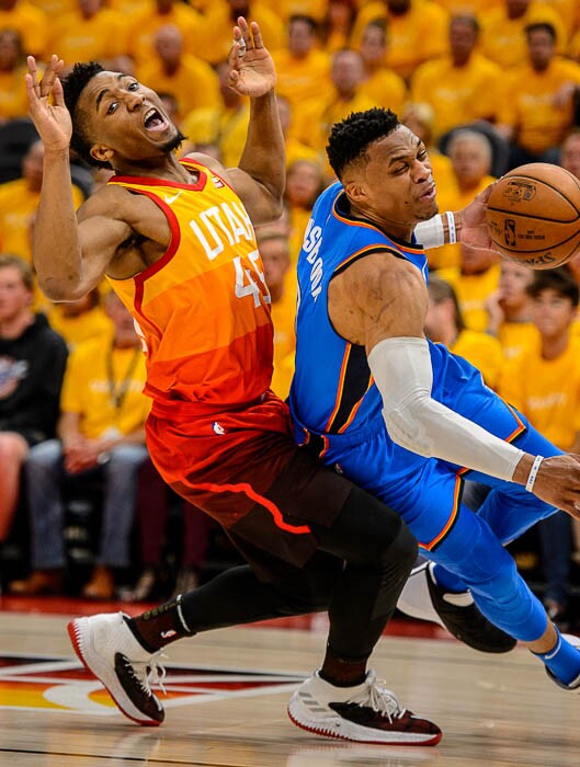 (Trent Nelson | The Salt Lake Tribune)  Utah Jazz host the Oklahoma City Thunder, Game 3, NBA playoff basketball in Salt Lake City, Saturday April 21, 2018. Utah Jazz guard Donovan Mitchell (45) fouls Oklahoma City Thunder guard Russell Westbrook (0).