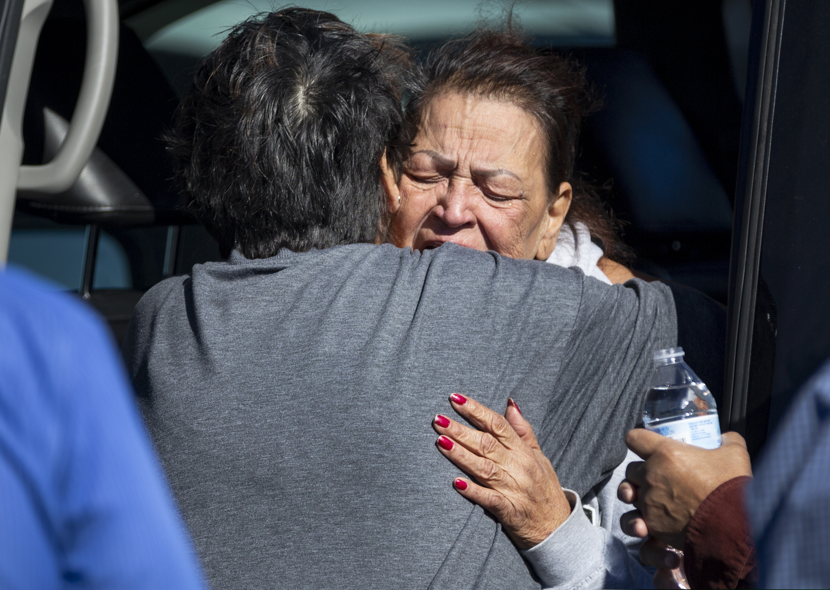 (Chris Landsberger | The Oklahoman via AP) A family member reacts at the scene of a fatal shooting in the parking lot of a Walmart in Duncan, Okla., on Monday, Nov. 18, 2019.