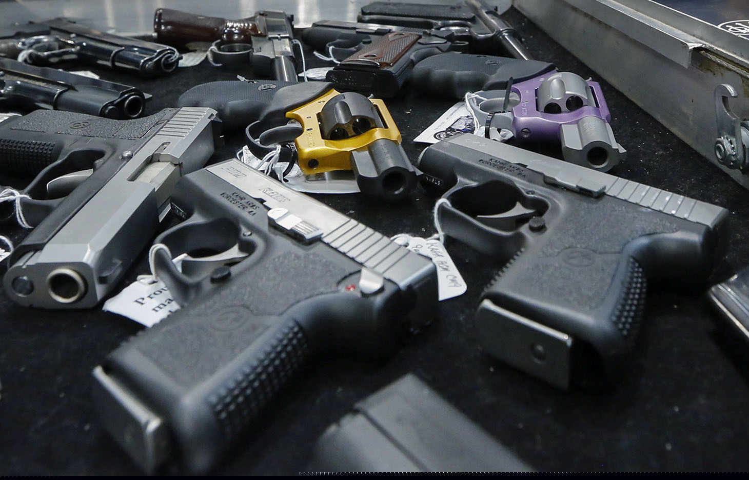 (Philip Kamrass | The Associated Press) In this Jan. 26, 2013, file photo, handguns are displayed on a vendor's table at an annual gun show in Albany, N.Y. In a study looking at data from 2006-14, serious gun injuries including many from assaults sent 75,000 U.S. children and teens to emergency rooms over the nine years. Results were released on Monday, Oct. 29, 2018.