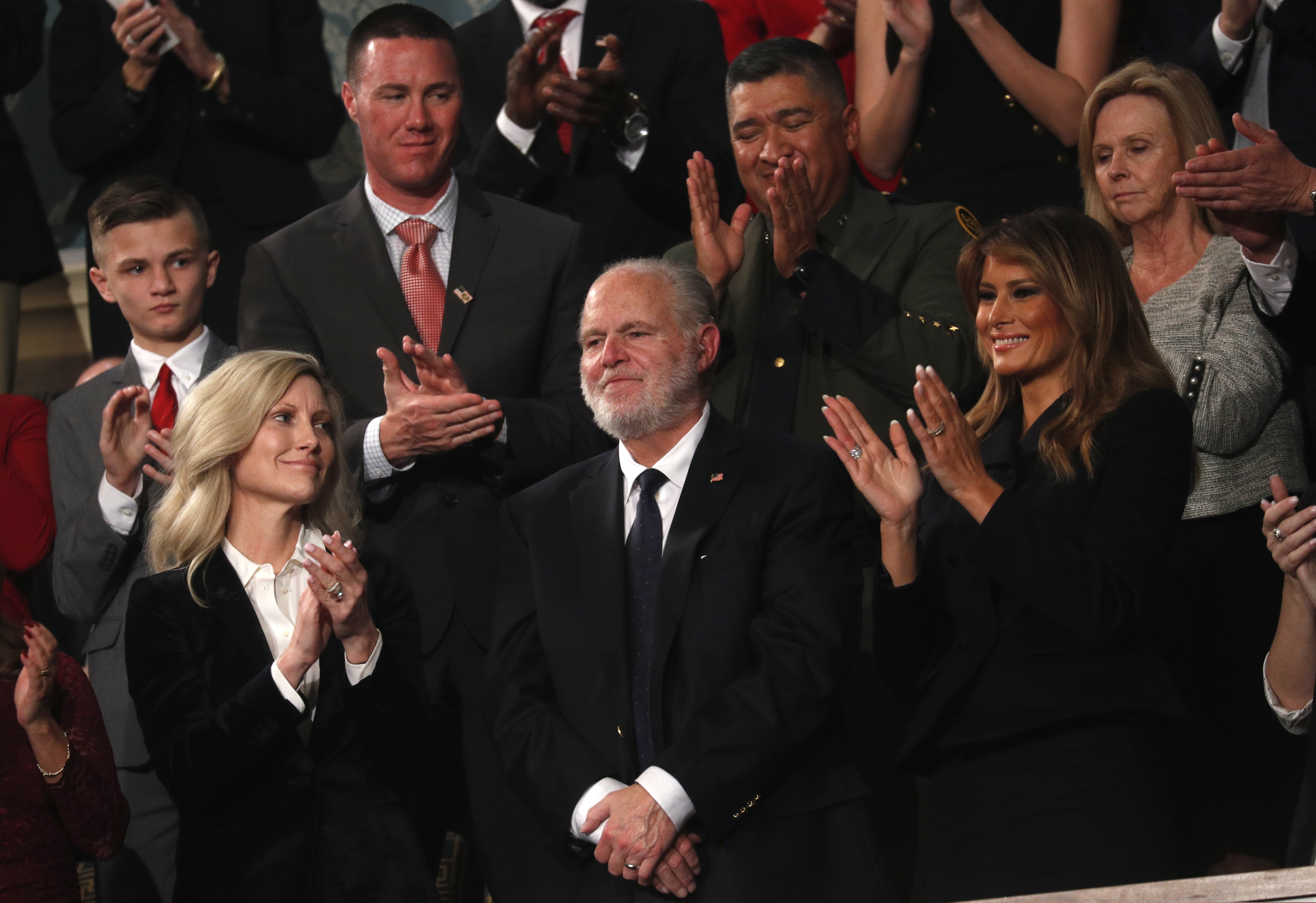 (Leah Millis | Pool via AP) Rush Limbaugh reacts as first Lady Melania Trump, and his wife Kathryn, applaud, as President Donald Trump delivers his State of the Union address to a joint session of Congress on Capitol Hill in Washington, Tuesday, Feb. 4, 2020.