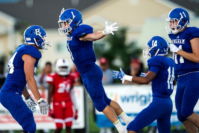 (Chris Detrick  |  The Salt Lake Tribune)  Bingham's Braedon Wissler (1) leaps into the arms of Bingham's Brody Price (74) as he celebrates his touchdown against during the game at Bingham High School Friday, August 25, 2017. Bingham is winning the game 24-17 at halftime. 