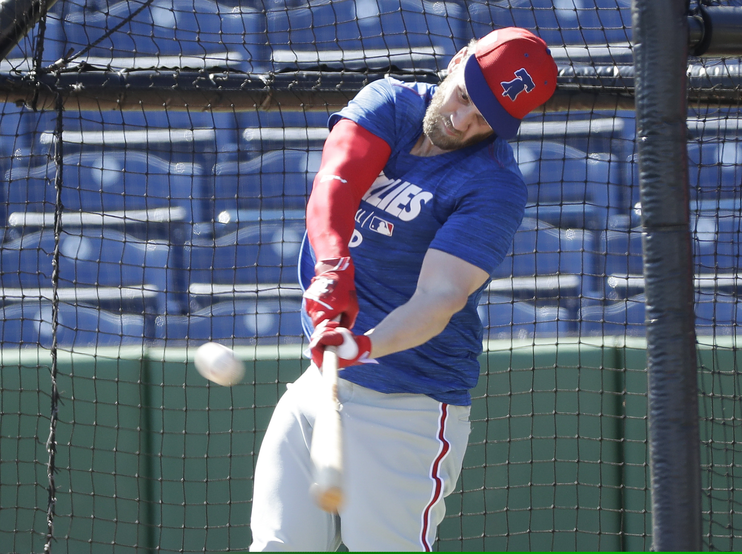 (Yong Kim | The Philadelphia Inquirer | The Associated Press) Philadelphia Phillies' Bryce Harper hits a baseball during batting practice Sunday, March 3, 2019, at Spectrum Field in Clearwater, Fla.