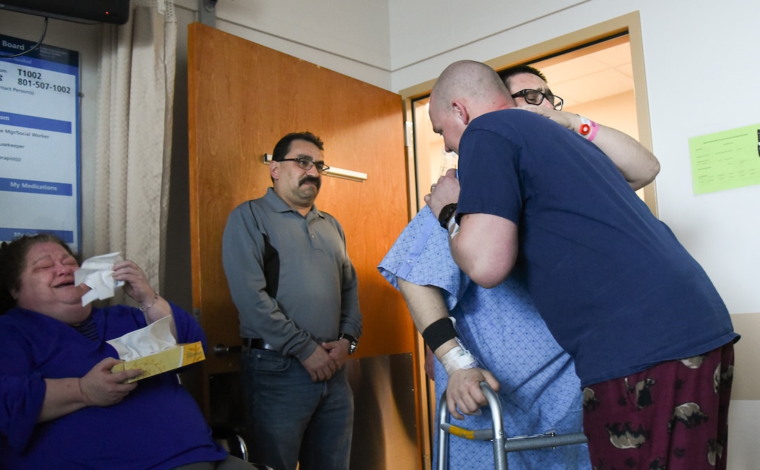 (Francisco Kjolseth  |  The Salt Lake Tribune)  Mitchell Salas, 30, center, embraces the man who saved his life when Matthew Thompson, 32, a Good Samaritan organ donor at Intermountain Medical Center generously donated his kidney to him. The two men are now "brothers for life" in the words of Salas who has battled kidney troubles since he was a baby. The two, who are still in the hospital met for the first time on Friday, March 29, 2019. Mitchell's parents Nancy and Willie Salas, at left, exclaimed "thank you for giving life back to my boy."