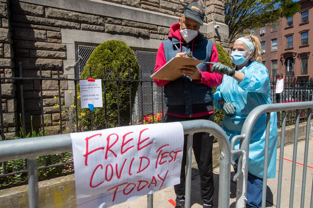 (Mary Altaffer | AP) Medical personnel help residents sign in for a COVID-19 test at the Bethany Baptist Church, Wednesday, May 13, 2020, in the Bedford-Stuyvesant neighborhood of the Brooklyn borough of New York. Churches in low income communities across New York are offering COVID-19 testing to residents in conjunction with New York State and Northwell Health.
