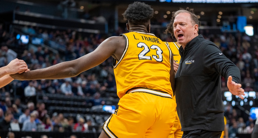 (Rick Egan | The Salt Lake Tribune) 
Long Beach State head coach Dan Monson, runs onto the court to help Long Beach State forward Lassina Traore (23) to his feet, in the First Round of the men's basketball NCAA Tournament at the Delta Center, on Wednesday, March 20, 2024.