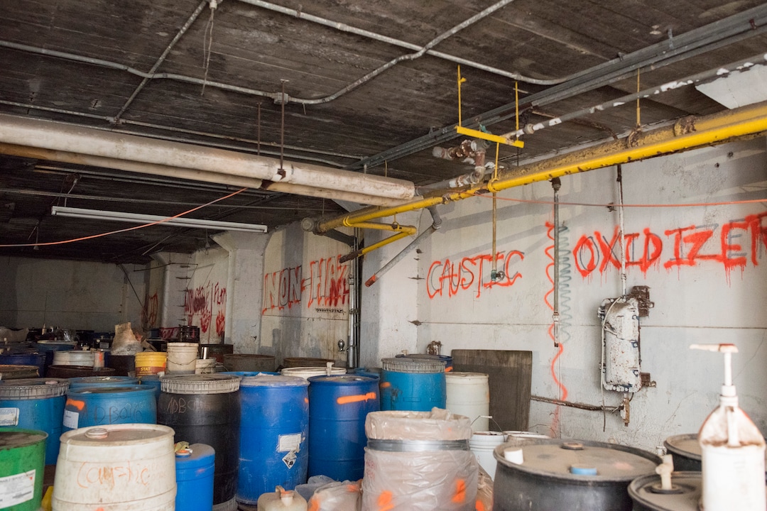 (Briana Scroggins  |  The Utah Investigative Journalism Project) Drums are organized by the properties of their contents in a lower level of the Swift building in Ogden on Thursday, May 16, 2019. On-scene Coordinator for the EPA Paul Peronard said that he expects the total number of containers to reach about 60,000. The EPA started site clean up on April 1 and plan to finish by August 2019.