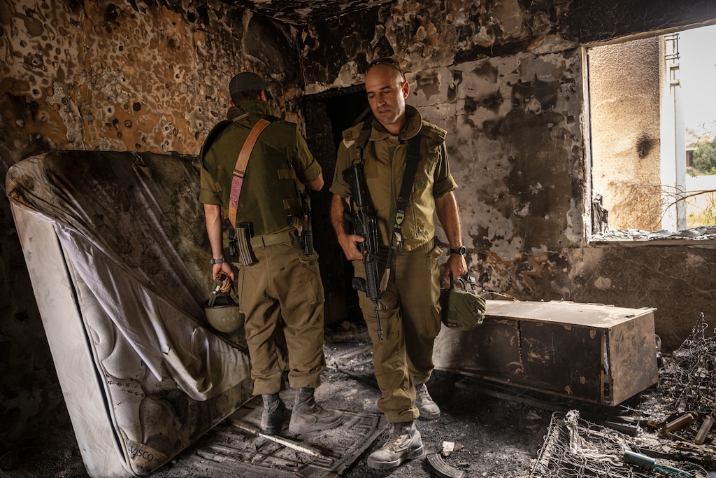 (Tamir Kalifa | The New York Times) Israeli soldiers survey a house that was destroyed in the Oct. 7 Hamas attack and subsequent battle with Israeli forces in Kfar Azza, Israel, Friday, Oct. 27, 2023.