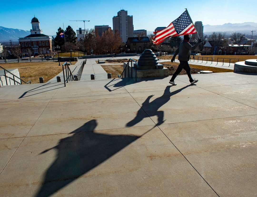 (Rick Egan | The Salt Lake Tribune) Jim White walks back and forth infront of the State Capitol with a tattered American Flag, protesting the corruption politicians and praying that God will change their hearts, on Tuesday Jan. 19, 2021.