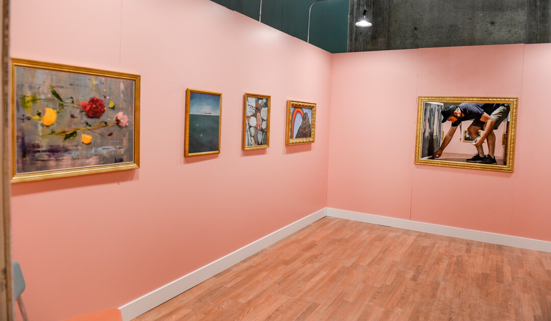 (Leah Hogsten  |  The Salt Lake Tribune) Love Letters Museum co-designer and artist John Connors squats in the opening behind a painting to reveal a tiny art show space that visitors can climb into as part of the Love Letters Museum show opening June 21, 2109. Love Letters is the newest 15,000-square-foot interactive art installation at The Gateway dedicated to the love of letters, as well as typography, books and literal love letters. “It is our attempt to use what we know best (letters, words, and art) to encourage each of our visitors to find and tell their own story. And to find the art in other's stories” -Love Letters Museum. ​