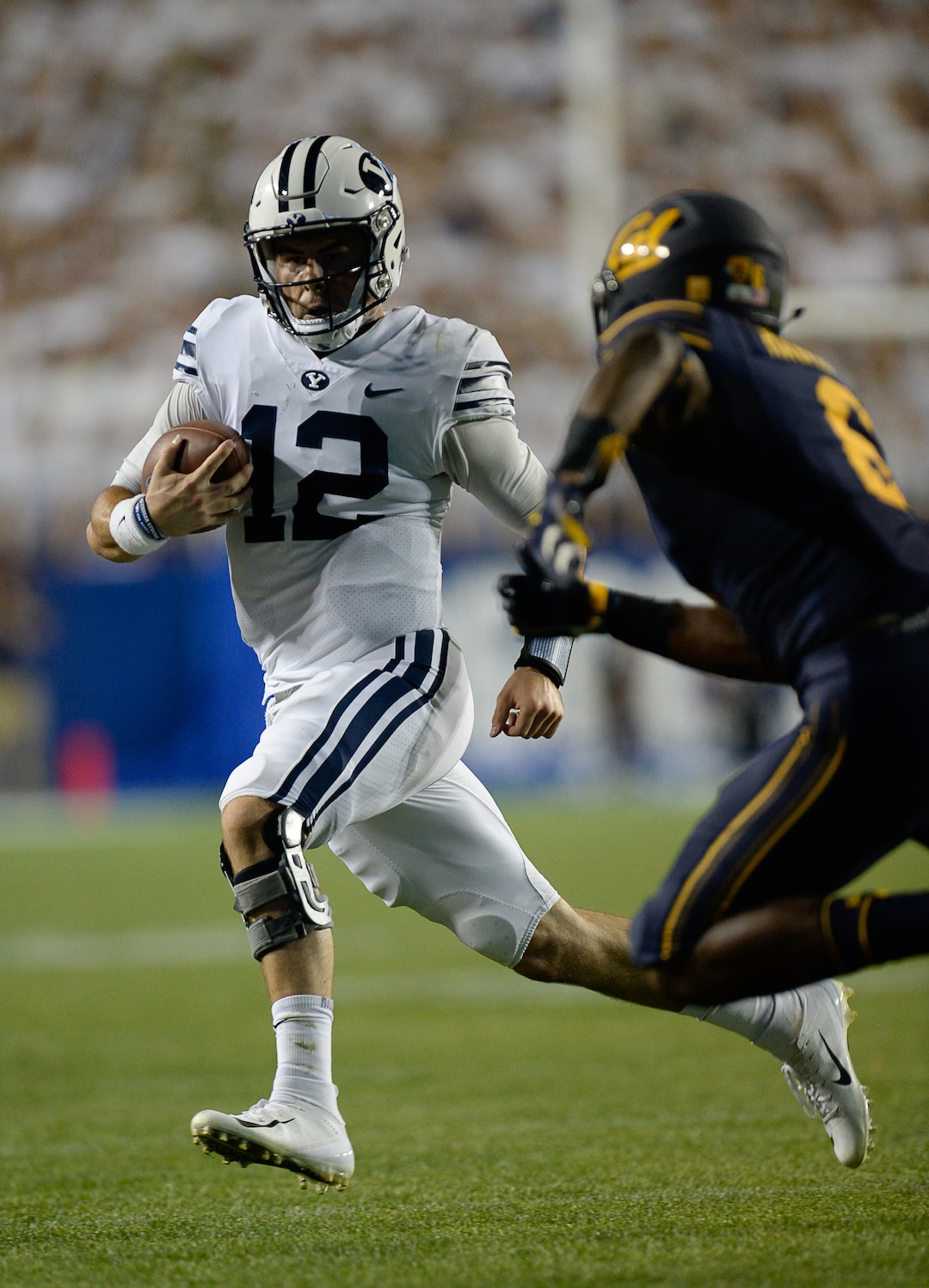 (Francisco Kjolseth  |  The Salt Lake Tribune)  Brigham Young Cougars quarterback Tanner Mangum (12) runs the ball against California during the first half of the NCAA college football game, Saturday, Sept. 8, 2018, at LaVell Edwards stadium in Provo, Utah.