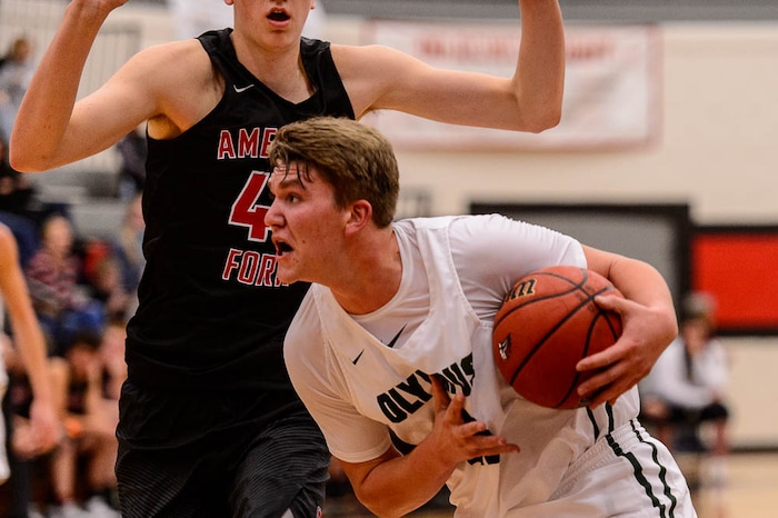 (Trent Nelson | The Salt Lake Tribune)  Olympus's Spencer Jones drives on American Fork's Isaac Johnson as American Fork hosts Olympus in the Utah Elite Eight tournament, Saturday December 9, 2017.