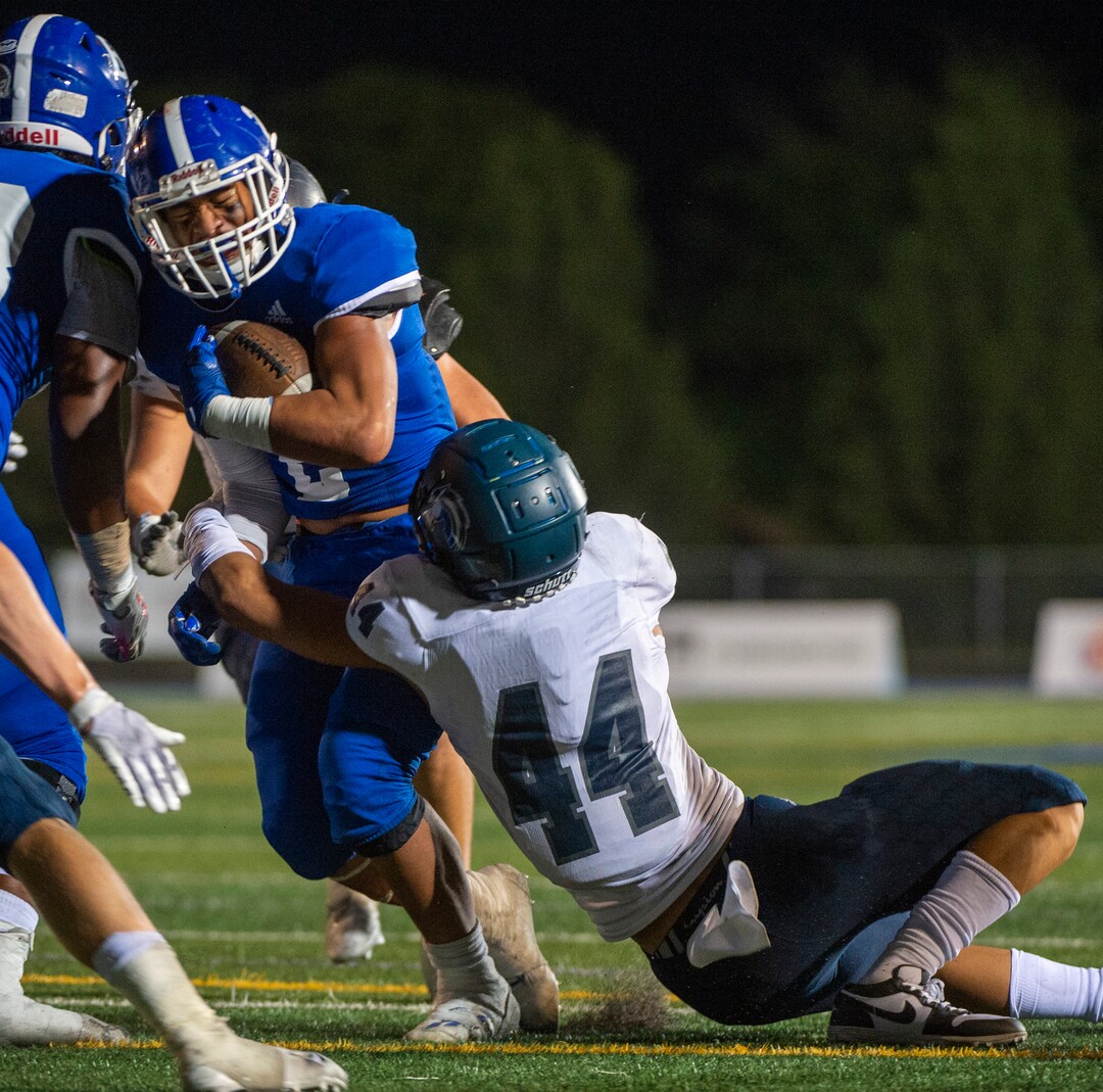 (Rick Egan  |  The Salt Lake Tribune)     Jaydon Kaio brings down running back Saia Lomu as he  runs the ball for Bingham, in prep action between the Bingham Miners and the Corner Canyon Chargers, at Bingham High on Friday, Aug. 28, 2020.