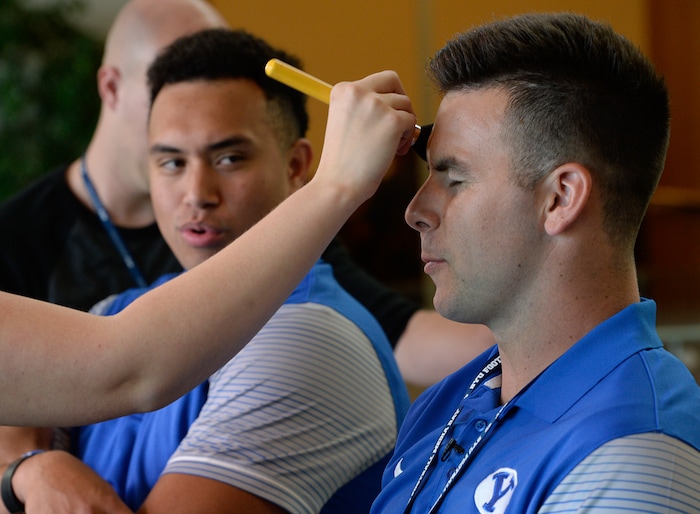 (Francisco Kjolseth  |  The Salt Lake Tribune)  Tight end Moroni Laulu-Pututau left, and quarterback Tanner are prepped for interviews during their eighth-annual football media day at the BYU-Broadcasting Building on Friday, June 22, 2018.