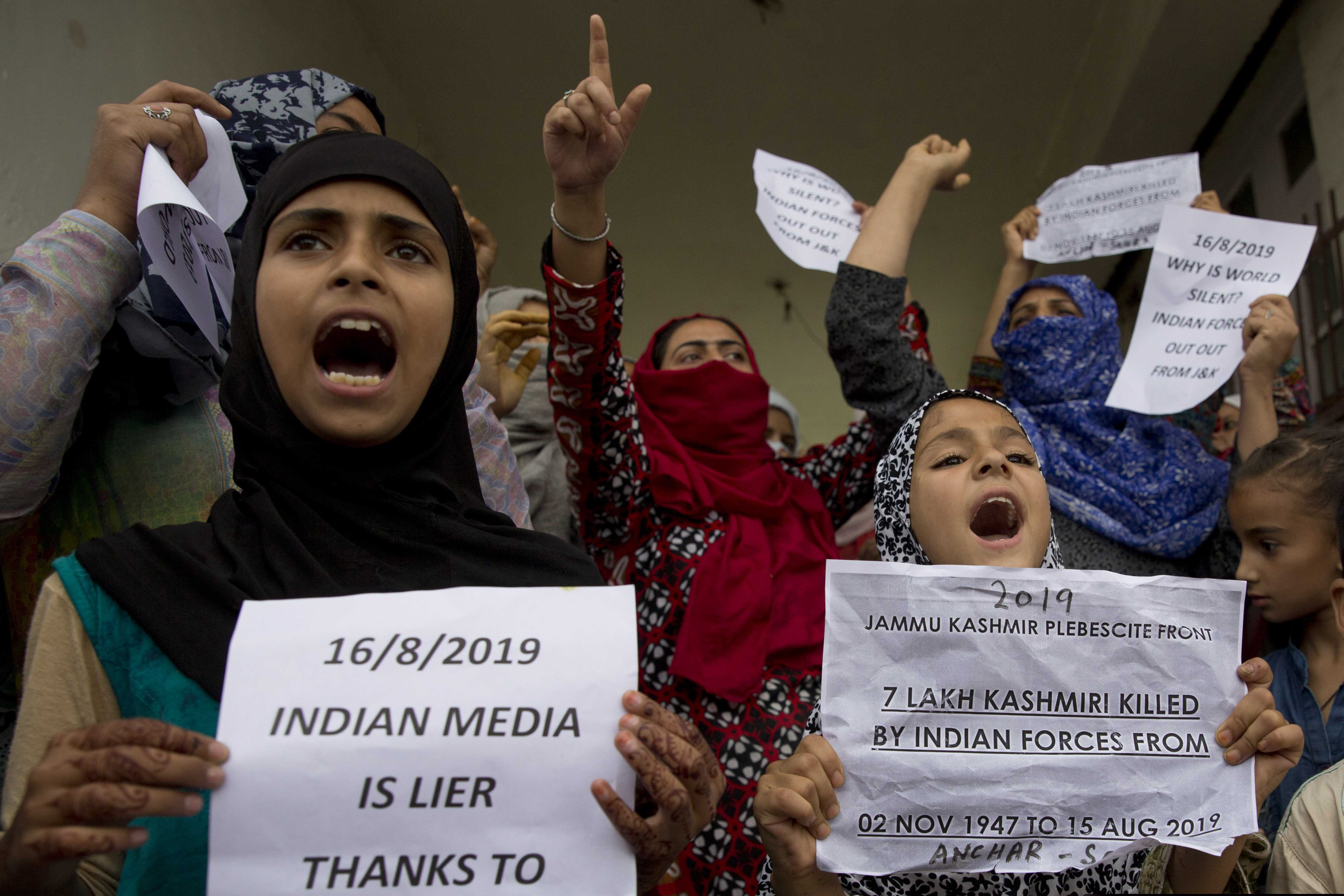 (Dar Yasin | AP Photo) Kashmiri Muslim women and young girls hold placards and shout pro-freedom slogans during a demonstration after Friday prayers amid curfew like restrictions in Srinagar, India, Friday, Aug. 16, 2019. Hundreds of people have held a street protest in Indian-controlled Kashmir as India's government assured the Supreme Court that the situation in the disputed region is being reviewed daily and unprecedented security restrictions will be removed over the next few days.