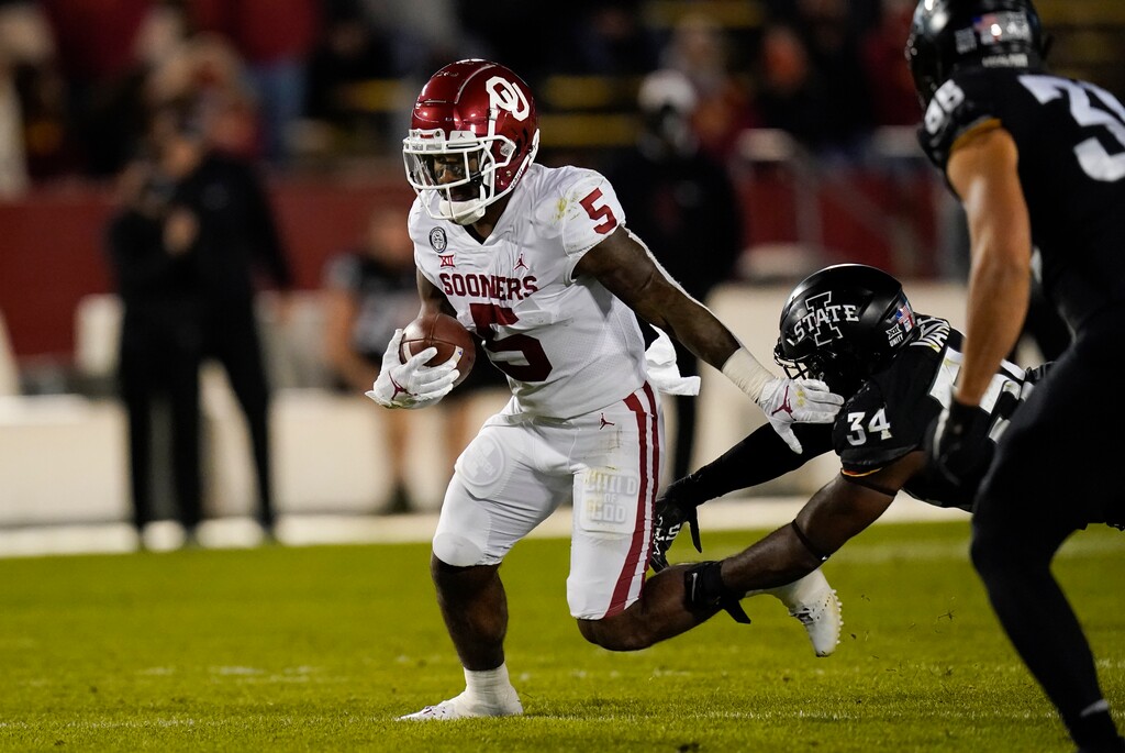 Oklahoma running back T.J. Pledger (5) runs from Iowa State linebacker O'Rien Vance (34) during the first half an NCAA college football game, Saturday, Oct. 3, 2020, in Ames, Iowa. (AP Photo/Charlie Neibergall)