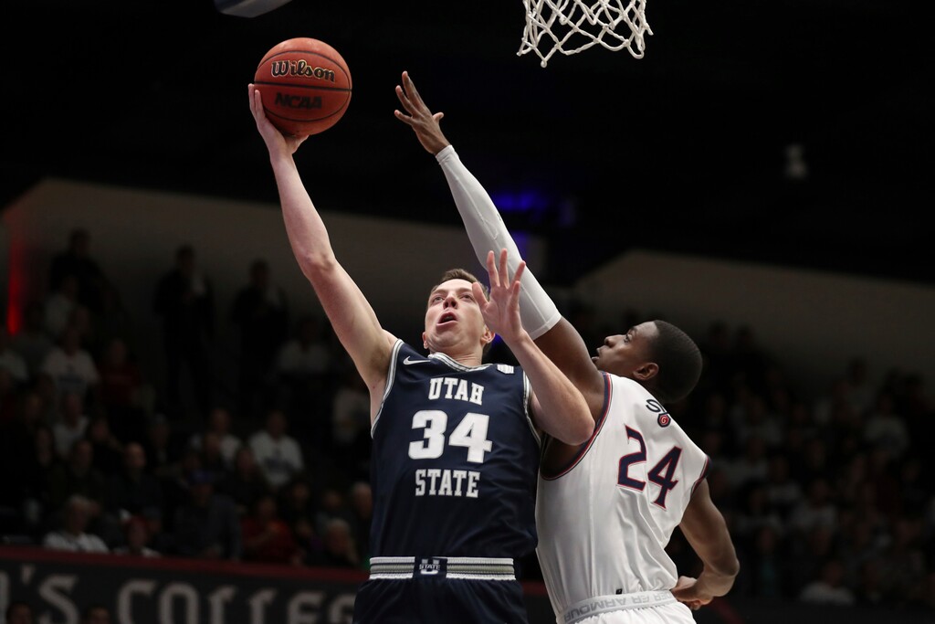 Utah State forward Justin Bean (34) shoots next to Saint Mary's forward Malik Fitts (24) during the first half of an NCAA college basketball game in Moraga, Calif., Friday, Nov. 29, 2019. (AP Photo/Jed Jacobsohn)