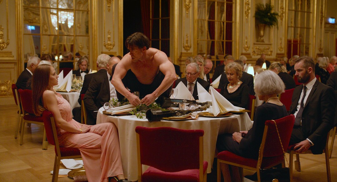 This image released by Magnolia Pictures shows Terry Notary, center, in a scene from "The Square."  (Magnolia Pictures via AP)