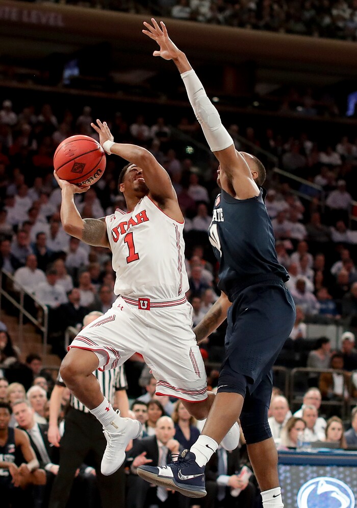 Utah guard Justin Bibbins (1) shoots against Penn State guard Tony Carr (10) during the first quarter of an NCAA college basketball game for the NIT championship Thursday, March 29, 2018, in New York. (AP Photo/Julie Jacobson)