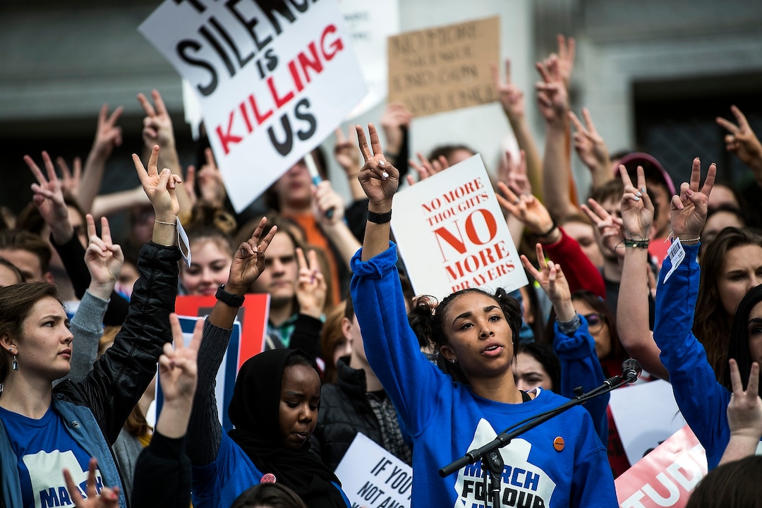 (Chris Detrick  |  The Salt Lake Tribune)  Participants hold up the peace sign as they listen to John Lennon's song 'Imagine' during the March for Our Lives SLC at the state Capitol Saturday, March 24, 2018. The student-led March for Our Lives SLC got underway about 11:30 a.m. with what police estimated were 8,000 participants walking from Salt Lake City’s West High School to the front steps of the state Capitol.