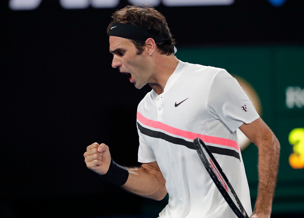 Switzerland's Roger Federer celebrates after winning a point against Croatia's Marin Cilic during the men's singles final at the Australian Open tennis championships in Melbourne, Australia, Sunday, Jan. 28, 2018. (AP Photo/Vincent Thian)