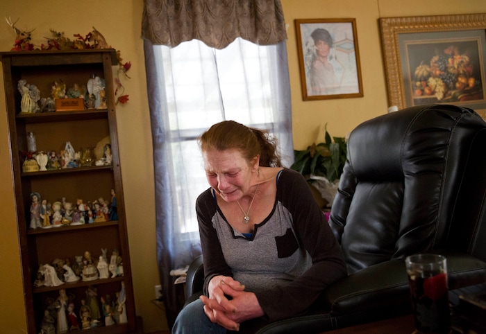 Linda Green, 51, cries in her home while awaiting trial after her latest arrest on charges of public intoxication in LaFollette, Tenn., Tuesday, March 27, 2018. "I've had a hard life. I'm on the edge. I feel like I'm going to have a nervous breakdown. ... Sometimes I want to go back on drugs just to numb the pain," she says. Green has been arrested more than 50 times in Campbell County on a range of charges from drug possession to theft. (AP Photo/David Goldman)