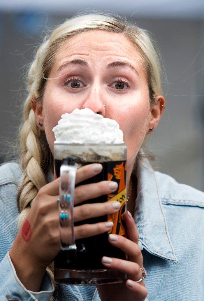 (Rick Egan  |  The Salt Lake Tribune)   Shayuin Romney from Bountiful licks the whipped cream from her beer at the Oktoberfest celebration at Snowbird. Sunday, Sept. 30, 2018.