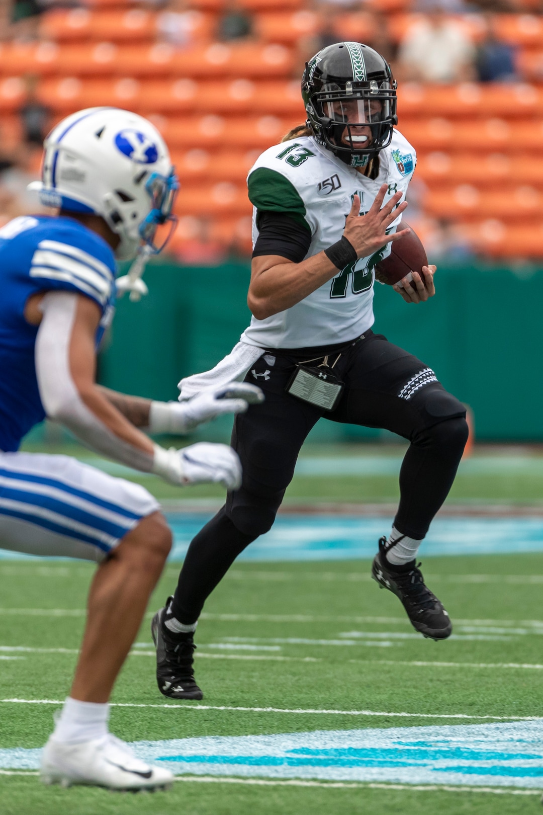 Hawaii quarterback Cole McDonald (13) runs with the football during the first half of the Hawaii Bowl NCAA college football game against BYU, Tuesday, Dec. 24, 2019, in Honolulu. (AP Photo/Eugene Tanner)