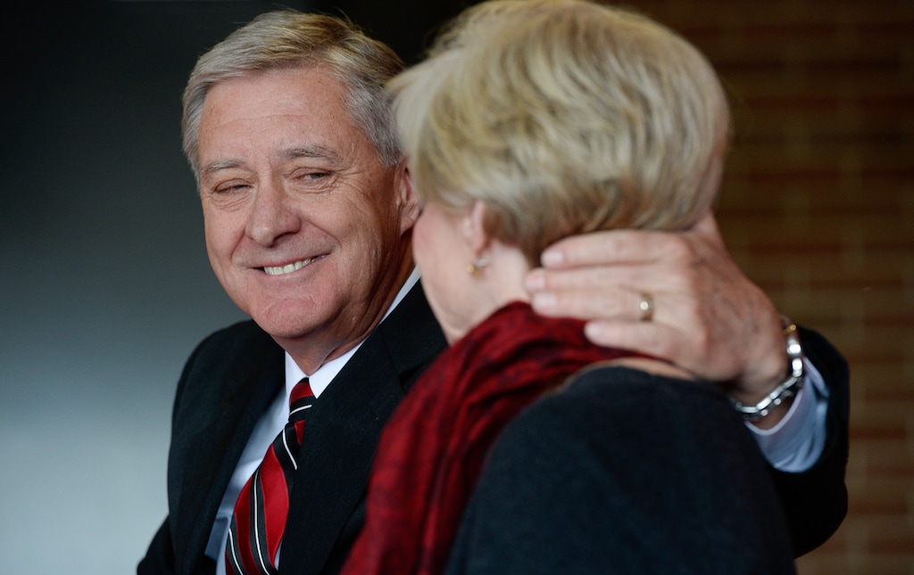 (Francisco Kjolseth | The Salt Lake Tribune) University of Utah Athletic Director Chris Hill acknowledges his wife, Kathy, as he announces his plan to retire this spring after 31years. Joined by friends and family at the Jon M. Huntsman Center on campus on Monday, March 26, 2018, Hill is the longest actively tenured athletic director at the same school in the NCAA FBS.