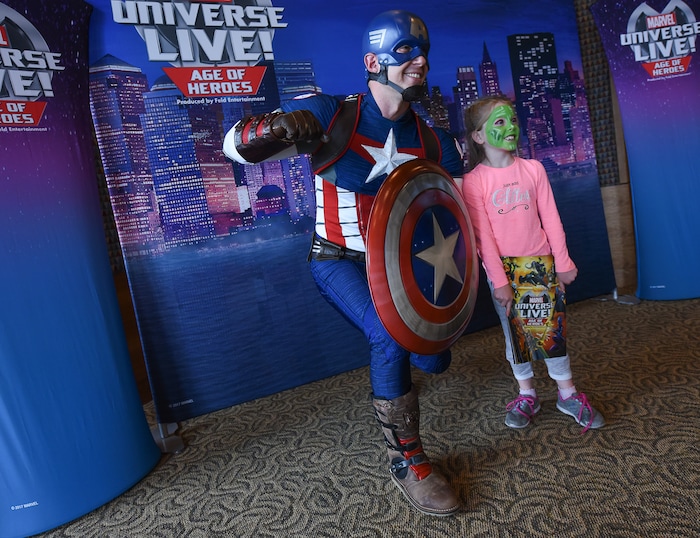 (Francisco Kjolseth  |  The Salt Lake Tribune)  Elle Wiet, 7, joins Captain America for a photo as Utah-based military families gather for the Salt Lake opening night of the all-new Marvel Universe LIVE! Age of Heroes, witnessing their favorite Marvel super heroes, including The Avengers, Spider-Man and the Guardians of the Galaxy in an action-packed adventure at the Maverik Center on Thursday, Sept. 28, 2017. MarvelÕs greatest military Super Hero Captain America was partnered with Got Your 6, a military veteran non-profit group dedicated to empowering veterans to lead and build stronger communities across America.